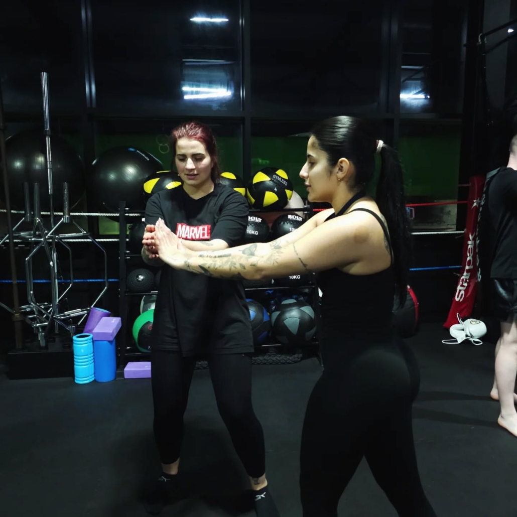 Trainer demonstrating proper kickboxing form Trainer demonstrating proper kickboxing form