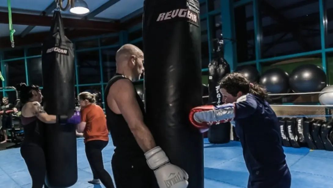 Focused athlete practicing with punching bag Focused athlete practicing with punching bag